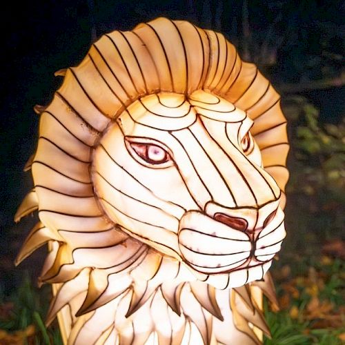 This image features a decorative lantern shaped like a lion's head, illuminated with intricate detailing and lines.