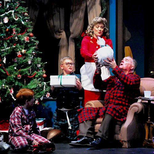 A festive Christmas scene with a decorated tree, people in pajamas, and a woman gifting an object, surrounded by presents and holiday decorations.